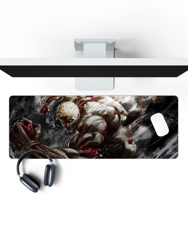 Armored Titan โ Reiner Braun Gaming Desk Mat on a desk, top view